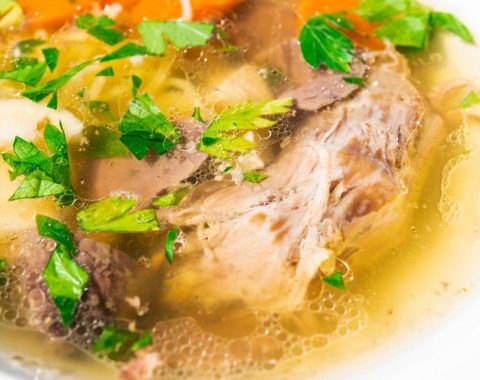 Homemade goose soup with vegetables and meat